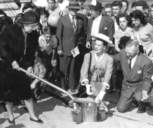 Janis Paige and dignitaries break ground with shovel and pail at McNary Dam.